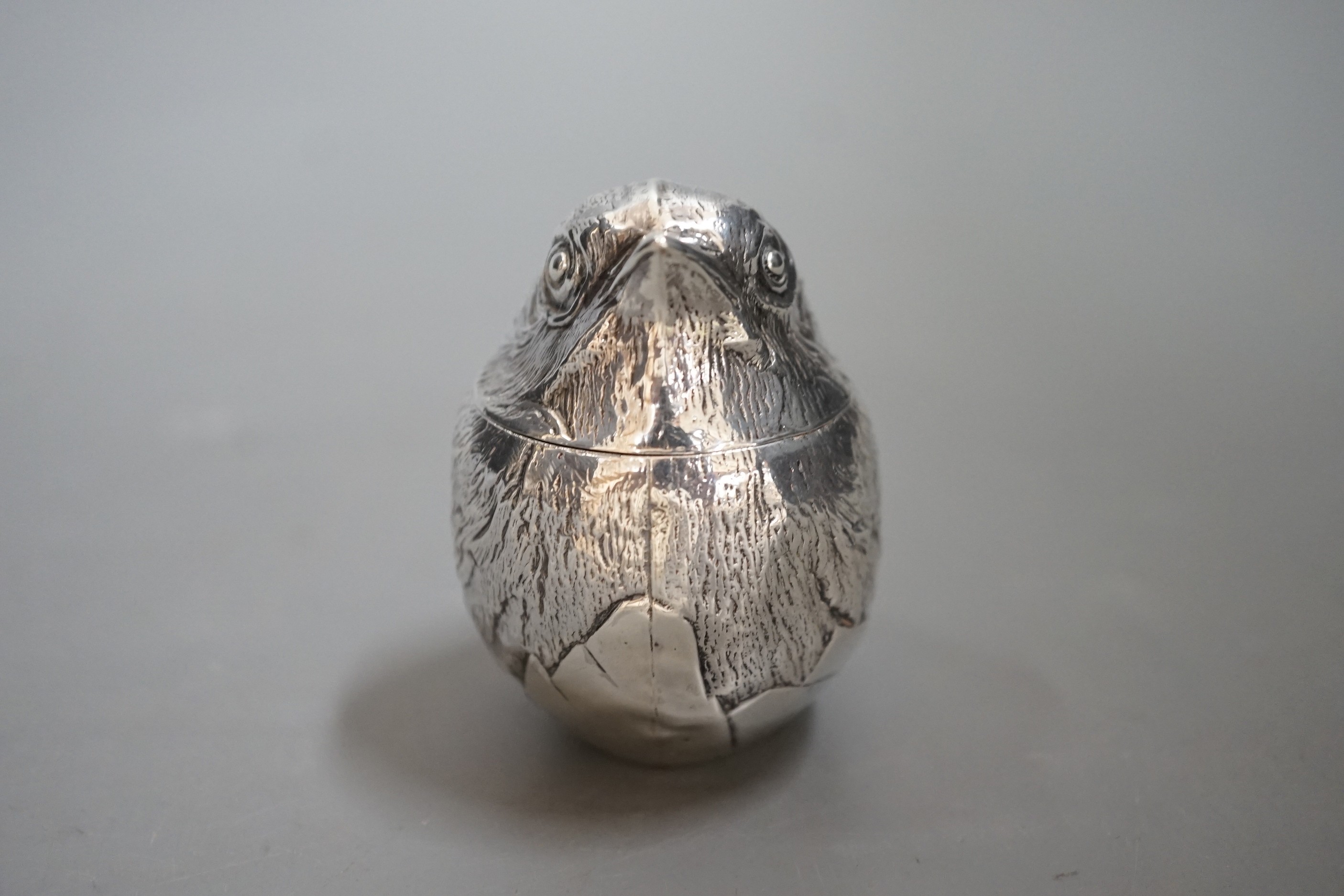 An early 20th century silver box with hinged cover, modelled as a hatching chick, Sampson Mordan & Co, Chester ?, marks rubbed, 64mm.